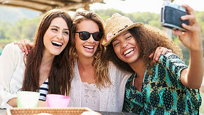 Three friends smiling and laughing while taking a selfie. Friendships are important in keeping good mental health. Marble Wellness if a mental health therapy practice located in chicago. Marble Wellness offers Anxiety Counseling, Depression Therapy and more.