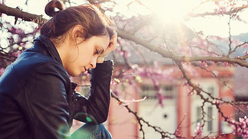 woman outdoor in springtime feeling sad and depressed. marble wellness can help with symptoms of depression and SAD. Marble Wellness is a therapy practice in ballwin, mo 63021.