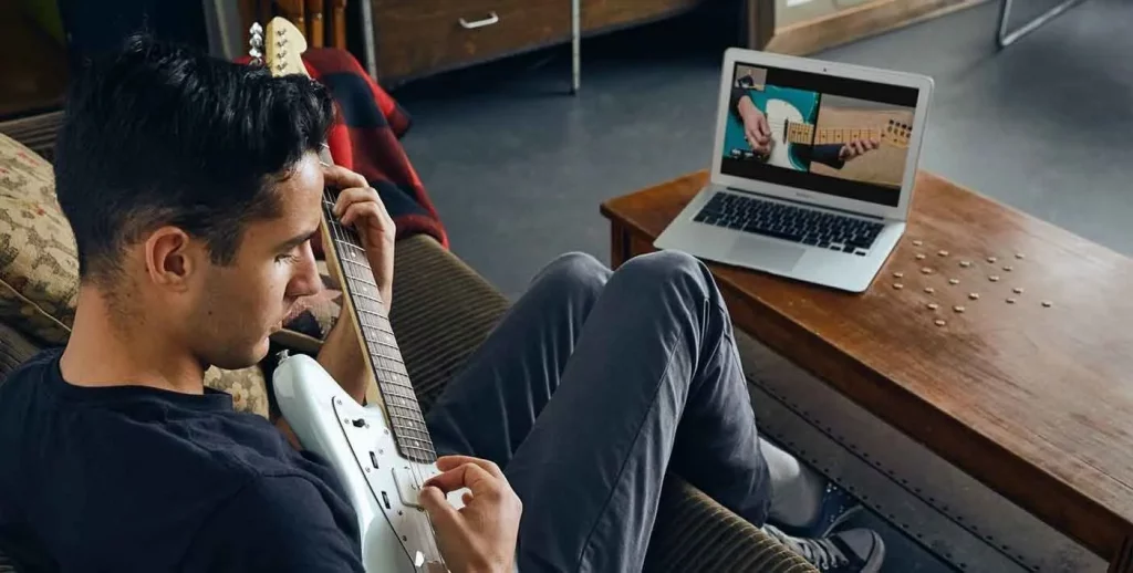 A younger man getting guitar lessons online. Marble Wellness always has helpful tips on ways to connect. Marble Wellness offers therapy for kids, teens, couples and adults. 