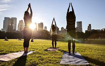 Some women doing yoga at the park in Chicago. Marble Wellness if located in Chicago and specializes in therapy for mental health. 