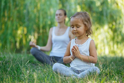 A child learning and practicing mindful breathing with her mother. Mindful breathing can help improve children's mental health. Marble Wellness is a Mental Health Practice offering Play Therapy for children ages 5 and up. Marble Wellness is located in 63011.