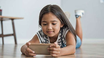 A young girl is using technology which may be a reason she is not getting enough sleep at night. Marble Wellness can help you and your child get back to better daily habits to improve mental health ad sleep. Marble Wellness offers Child Therapy using Play Therapy techniques for kids ages 5 and up.