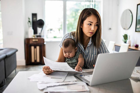 A mother on her laptop working with her baby on her lap. Marble Wellness offers help to working mothers dealing with the weight of it all. Marble Wellness is located in Chicago. IL and is accepting new clients for in person or virtual sessions.