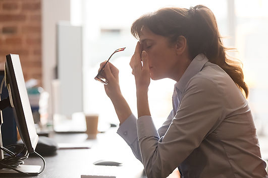 A woman crying at desk. Marble Wellness offers therapy/counseling to working professional women who needs guidance in feeling better. Marble Wellness is located in Chicago, IL.