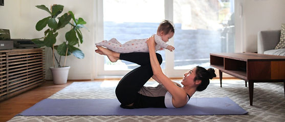 A mother at home doing yoga with her baby. She is trying to find time for herself. Marble Wellness offers therapy services both in person and virtually for mothers who are feeling like they lost themselves and their identity. 