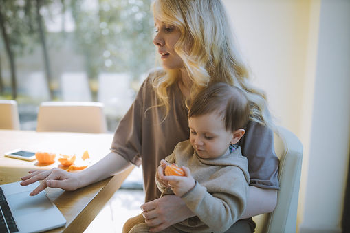 A mother on her work laptop and holding her son. She looks stressed. Marble Wellness offers counseling for Working Moms dealing with burn-out. Marble Wellness is located in Chicago, IL and offers in person or virtual sessions. 