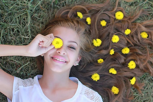 A happy teen who is smiling and seems peaceful. Marble Wellness offers Therapy for Teenagers and specializes in Teen Counseling. Marble Wellness is located in STL and offers in person and virtual therapy sessions as well as walk and talk therapy.