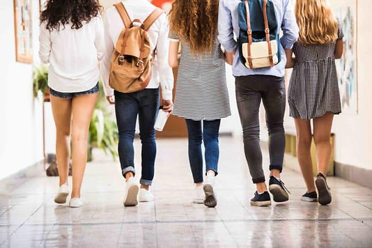 Five teenagers walking the halls together at school. Teen mental health struggles are on the rise and Marble Wellness is here to help. Marble Wellness specializes in Teen Counseling. Marble Wellness is located in West County, MO and offers therapy in person or virtually. 