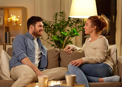 A couple talking on a couch seemly happy and in a good relationship. Communication is so important in a relationship and Marble Wellness is here to help support that. Marble Wellness offers Couples Therapy both in person or virtually.