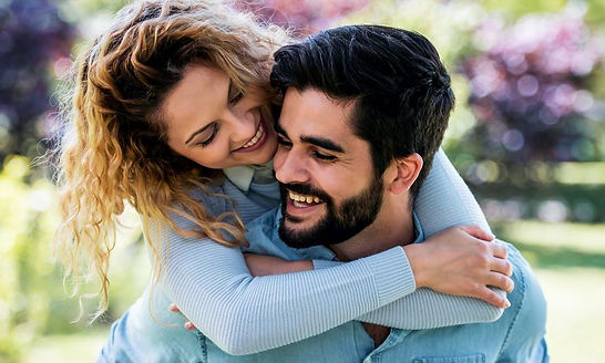 A couples hugging and smiling appearing happy. Marble Wellness offers couples counseling for relationships and marriages. Marble Wellness is located in St. Louis, MO. 