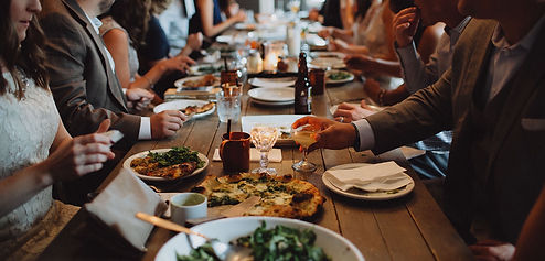 A beautiful table of food drinks and people gathered for a holiday meal. The holidays can be so stressful for many and Marble Wellness can help you navigate through these times. 