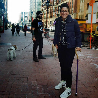 A woman with a chronic illness and using a cane to walk. She is young and outside enjoying the day. Marble Wellness has a Chronic Illness Therapist in STL.