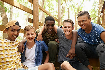 A group of teen boys hanging out together having fun. Marble Wellness offers teen counseling for in person or virtual sessions. Marble Wellness is located in STL.