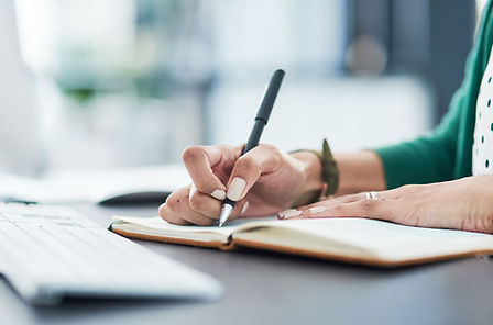 A woman writing out a plan in her journal. Marble Wellness is a mental health practice in St. Louis and Chicago offers therapy for many specialties. Marble Wellness is taking new clients.