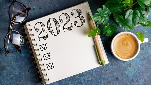 A 2023 blank notebook with a pen. Marble Wellness can help you reach your goals this year. Marble Wellness specializes in anxiety, depression, life transitions and more!