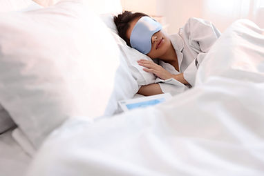 A woman sleeping with an eye mask on in bed. Sleep is so important for mental health. Marble Wellness is a mental health practice specializing in Therapy for Anxiety, Therapy for depression, Grief, Teen, Mens mental health and more!
