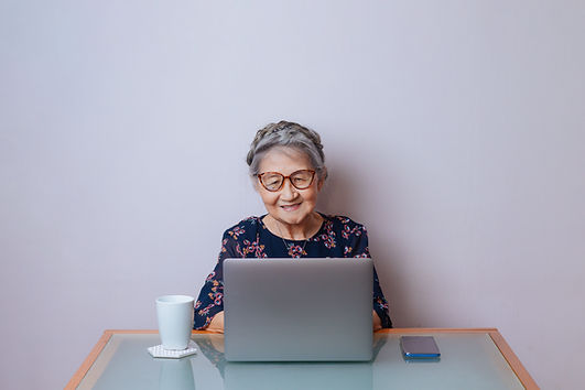 Woman looking at her laptop. Therapists at Marble Wellness are available for in-person and virtual therapy in Missouri and Illinois. In-person therapy can be especially beneficial for those wanting counseling for chronic illness.
