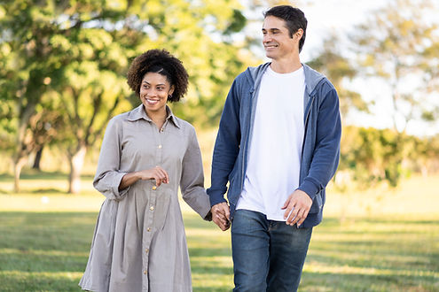 A couple takes a walk in a park in Saint Louis, Missouri. Couples counseling is a specialty of Marble Wellness, a therapy practice near me in Saint Louis, MO.