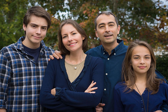 Two parents, a teenage boy, and a teenage girl stand together in a park. For concerns about substance abuse in teen boys, teen therapy and substance abuse therapy are specialties of Marble Wellness. Families in St. Louis can find support through in-person therapy in St. Louis, online therapy in Missouri, and park therapy in St. Louis.