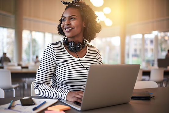 A woman works on her laptop in her office. Working with a therapist can ease the transition back to work after maternity leave. Marble Wellness in St. Louis, MO 63011 helps mom through life transitions.
