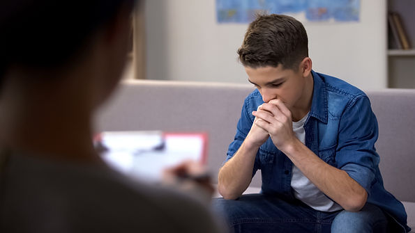 A teen boy attends a therapy session. Marble Wellness offers counseling for teens, counseling for substance abuse, counseling for kids, counseling for adults, counseling for couples, and counseling for families in St. Louis, MO.