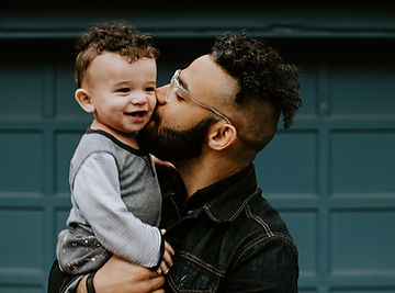 Dad kissing son on cheek | postpartum support in St. Louis, MO | postpartum depression | online counseling | in-person counseling | postpartum counseling | therapist for postpartum depression near me | 63043 | 63011 | 63102