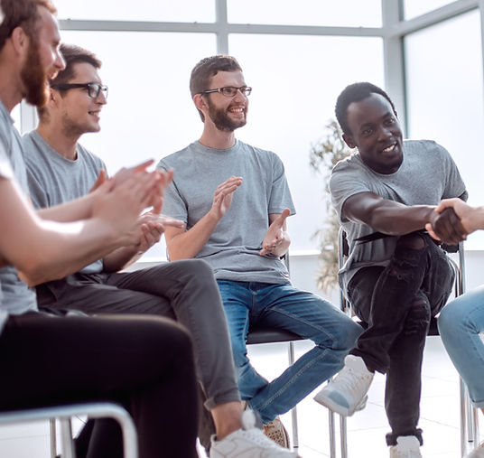A new dad attends a support group with other men. Therapy for men in St. Louis is available at Marble Wellness through in-person therapy, online therapy in Missouri, online therapy in Illinois, and park therapy.
