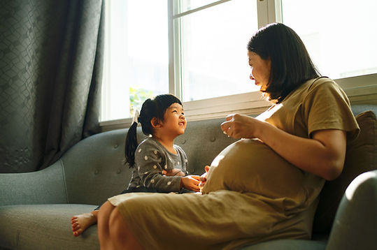 A woman and her daughter smile at each other while sitting on a couch. Motherhood can feel even harder when cognitive distortions impact your life. Marble Wellness is a therapy practice in St. Louis, MO that specializes in therapy for moms, couples counseling, child therapy, therapy for teenagers, and men's mental health.