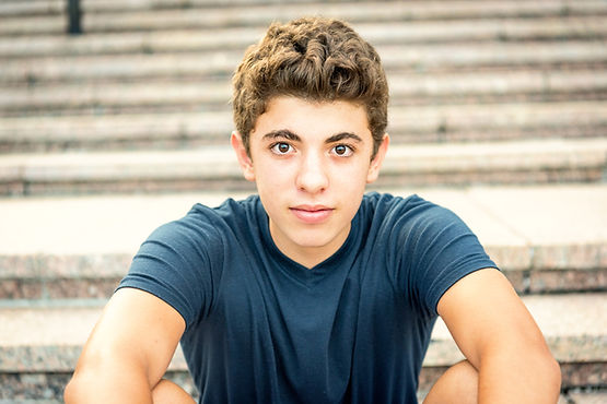 A teenage boy looks at the camera. Teen therapy, family therapy, and child therapy are offered by Marble Wellness, a therapy practice in St. Louis, MO. Marble Wellness offers in-person therapy, online therapy in Illinois, online therapy in Missouri, and park therapy in Queeny Park.