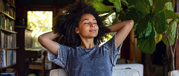 A black women looking calm and at peace after anxiety therapy. Marble Wellness offers Anxiety Counseling and can see clients in person or virtually.