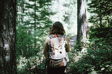 A girl hiking, using that as self-care while grieving. Marble Wellness, a counseling practice in St. Louis, MO has a grief counselor that can support you with your grief journey.