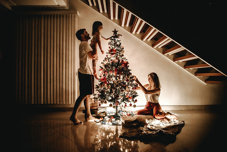 A family decorating their tree at Christmas | Individuals comforting friend | grief counseling | grief counseling in St. Louis, MO | online grief counseling in Missouri | in-person therapy | online therapy | Ballwin, MO 63043 | 63011 | 63101 | 63102