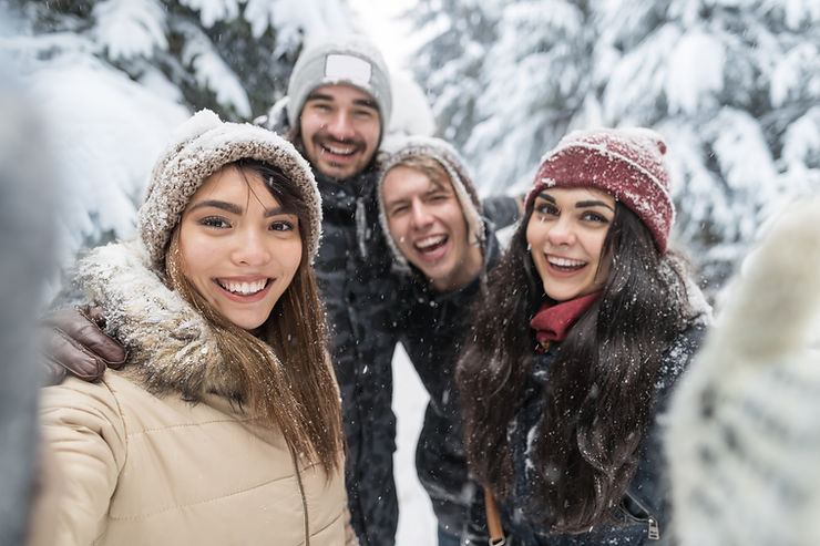 Group of friends taking a selfie in a nature walk in winter. Making friends in adulthood is hard but can be done with these tips from Marble Wellness.