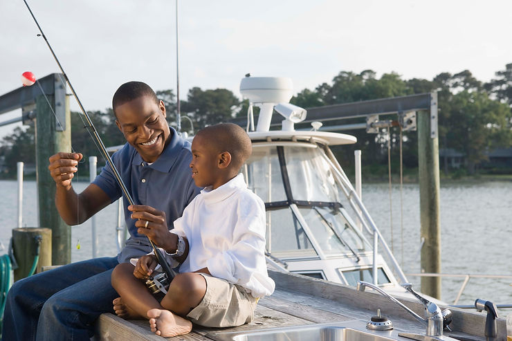 Father and son fishing. Marble Wellness has therapy for men in St. Louis and also does counseling for men in Chicago, IL. Reach out today to start your therapy journey!