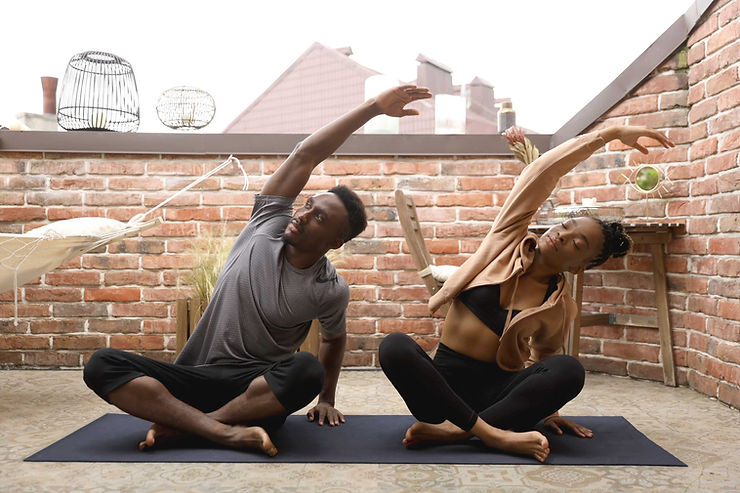 A couple doing yoga on a rooftop. Exercising together is a way for a person to support their partner's mental health. Marble Wellness is a counseling practice that can work with you to establish healthy relationships, with yourself and others. Call us today to get started with virtual therapy in MO or in-person therapy in West County, MO