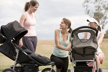 Three moms in park with strollers. Marble Wellness offers therapy for moms in St. Louis, MO. We can help overwhelmed moms feel less stressed, more capable, and happier. Call today to start with one of our in-person West County therapists!