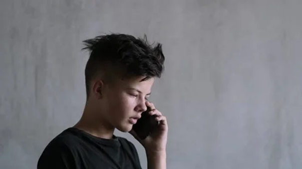 A depressed teenage boy making a call for help. Having a safety plan is important. Marble Wellness offers therapy for teen and therapy for anxiety, depression and much more. Marble Wellness is located in STL Missouri.