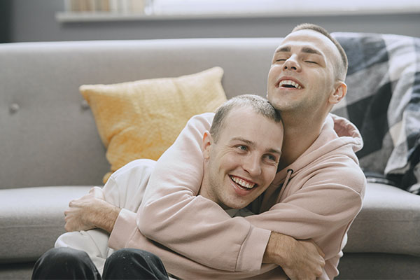 Photo of a happy LGBT couple playing and enjoying quality time together after a session with couples therapy in St. Louis, MO. They can become a duo again after couples and marriage therapy in St. Louis, MO. Find your flow with Marble Wellness Counseling in Kirkwood and online therapy in Missouri. We offer many services, but if you're learning to work through a difficult relationship season, try couples counseling in Kirkwood, MO.