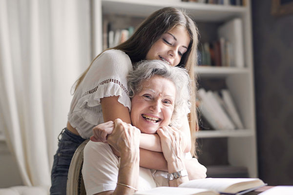 Photo of a girl hugging her grandma feeling peace and hope after grief counseling in St. Louis, MO 63011. You can heal from the grieving process with online therapy in Missouri, park therapy in West County, MO, and counseling for women in Missouri.