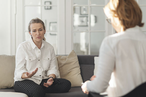 Photo of a woman with a sad expression, explaining her situation to her therapist in a session of in-person therapy in Chicago, IL with Marble Wellness. If you want to have in-person therapy in Chicago we are here for you.