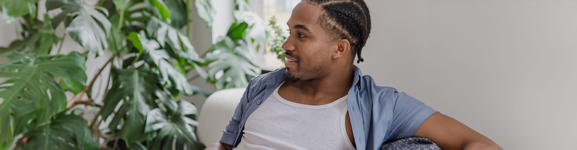Photo of a receptive and relaxed man waiting on a couch getting ready to begin a counseling session. You can feel better with therapy directed especially to men in St. Louis, MO at Marble Wellness.
