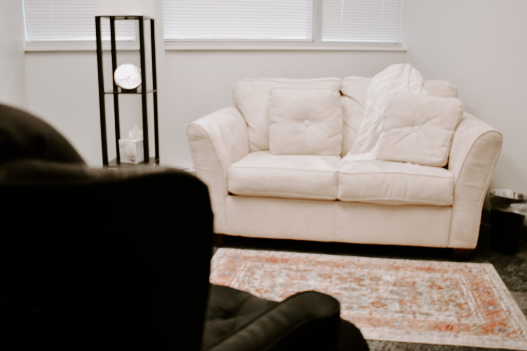 Client couch in a therapy office at Marble Wellness, a St. Louis, MO counseling practice. We serve moms, couples, kids, and teens. We can help with anxiety, depression, grief, chronic illness, and maternal overwhelm. Reach out today!
