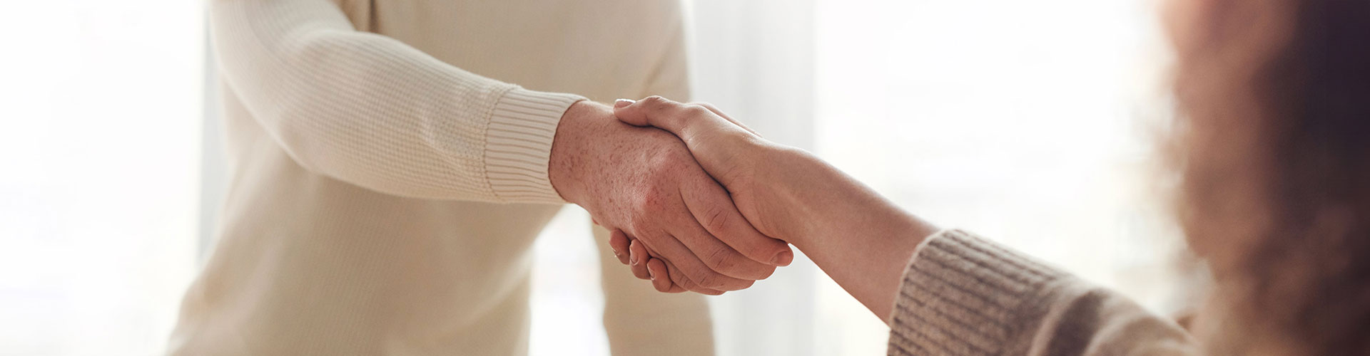 Photo of a handshake over a table at the end of an interview. Check out our job openings and join our team at Marble Wellness.