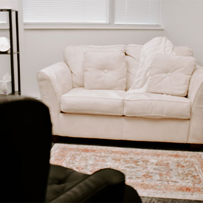 Photo of a white couch in a therapy room at the Marble Wellness office in St. Louis.