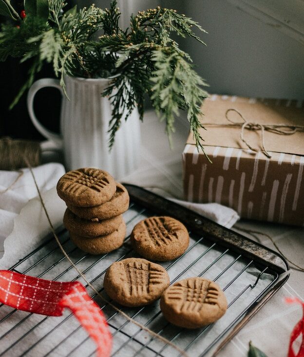 A plate of homemade cookies and handmade gift with ribbon. Giving a gift of your time or talent can help with Holiday depression. Schedule a meeting with a licensed counselor today.