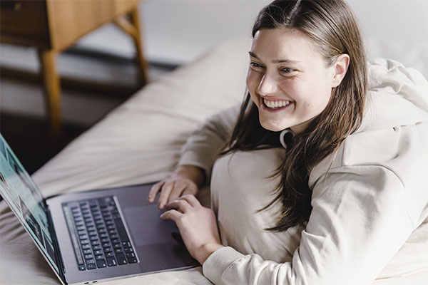 Photo of a woman smiling after an online therapy session for depression at Marble Wellness, Chicago, IL. We also offer in-person therapy at our office in the West Loop Neighborhood.