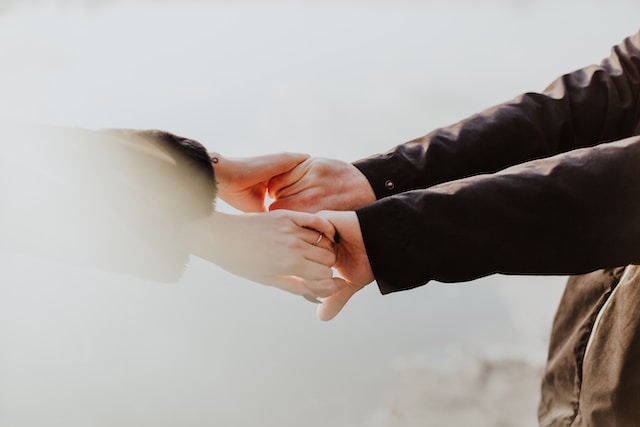 Man and woman arms outstretched holding hands. Couples counseling can enhance a relationship. Call to schedule a couples counseling session today.