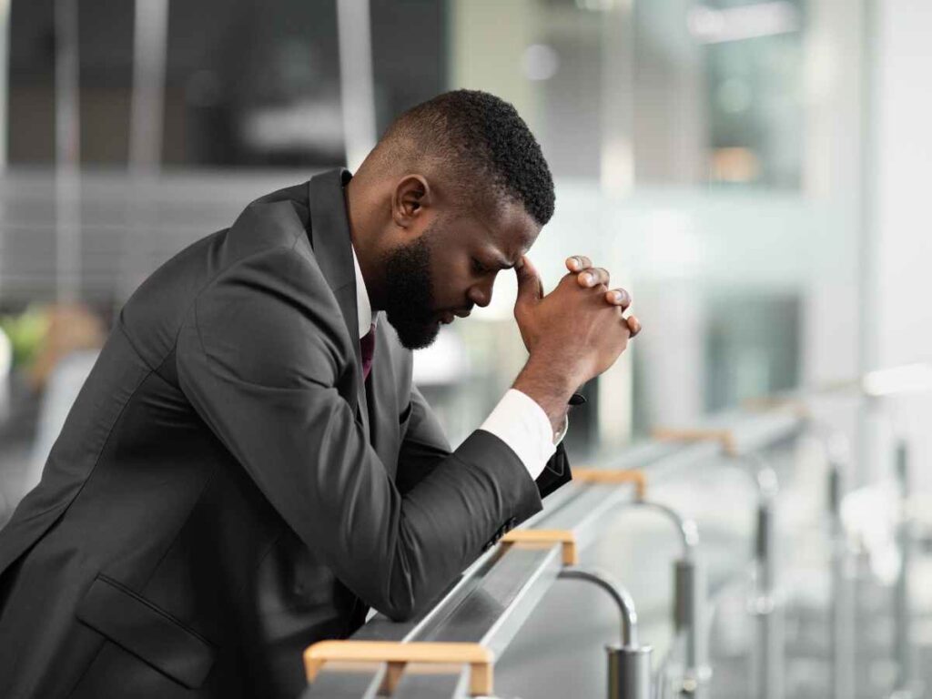 Stressed and worried autism parent putting his elbows on a railing and his head on his hands. For support from an STL therapist, reach out to Marble Wellness. Providing therapy for special needs parents in University City, Ladue, Frontenac, and Clayton. 