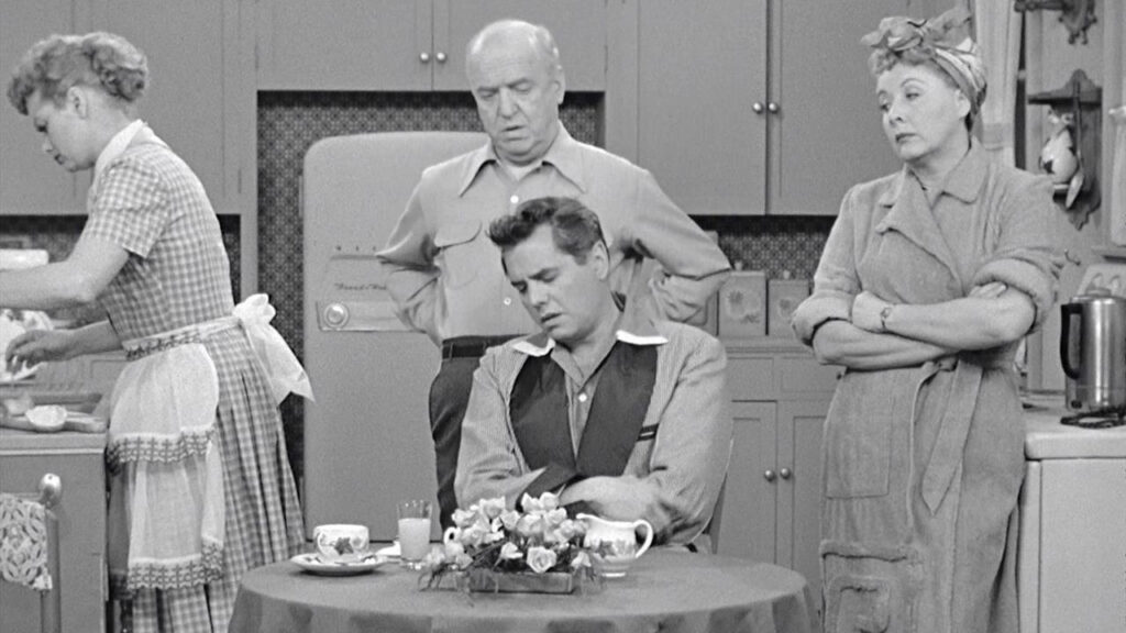 Photo from the TV show I Love Lucy with everyone around a small kitchen table looking irritated. A Ballwin, MO therapist speaks to mom burnout, overwhelm and social pressure of the holidays here.