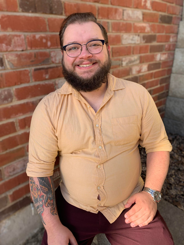 Therapist Jake Bava, looking at the camera and smiling. Jake works with teens, couples, and young adults in Ballwin, MO to feel better and find ways to thrive in life!
